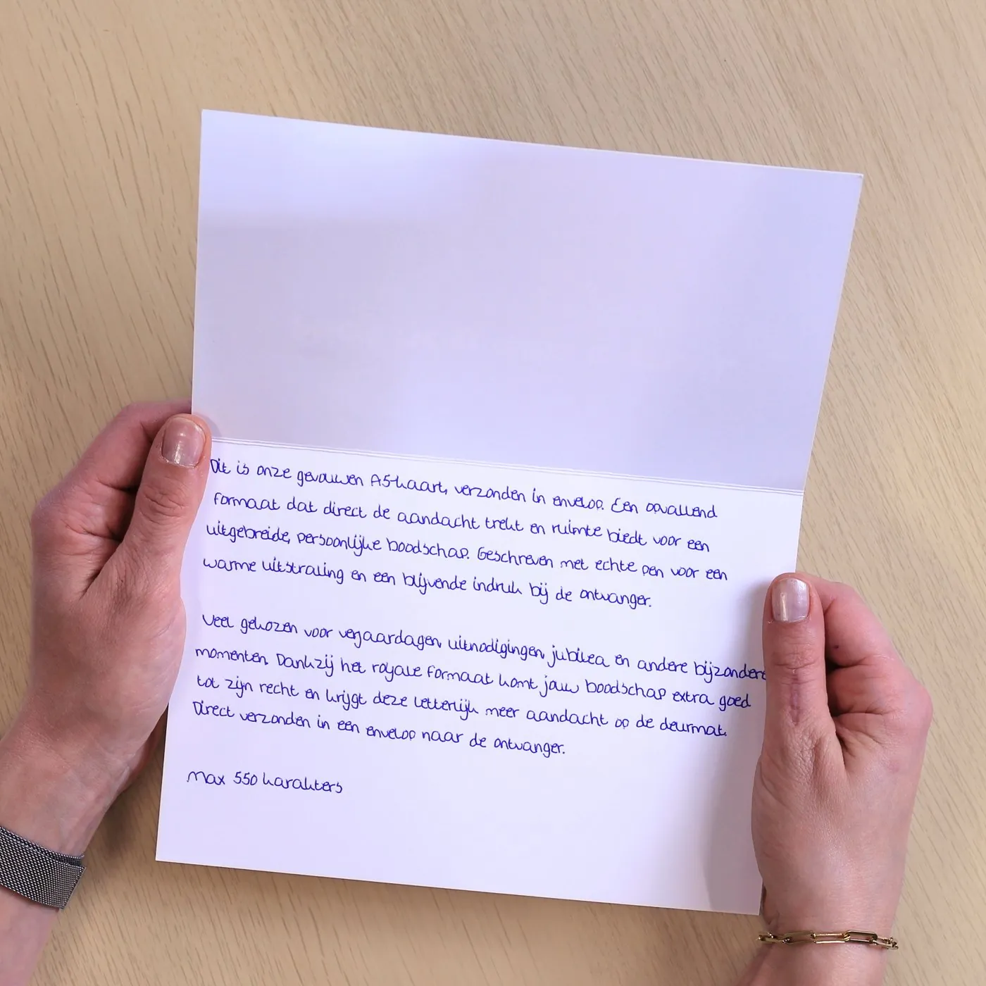 Horizontally folded A5 card, opened, written with a real pen at the bottom
