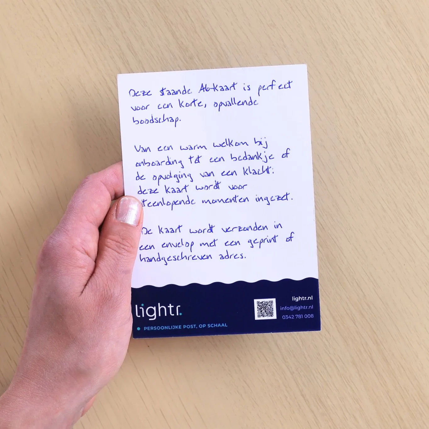 Portrait A6 card, written with a real pen, with the Lightr logo and a QR code at the bottom